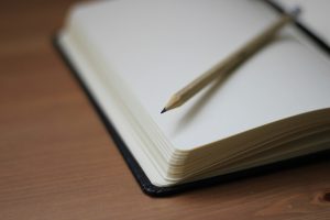 Blank notebook with pencil on table